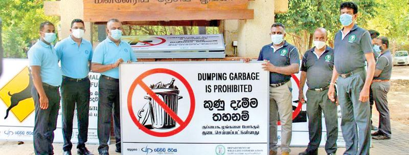 Deputy General Manager (Vehicle Sales Operations) Kosala Ratnayake officially handing over the hoarding to Bhathiya Madugalle, Warden, Minneriya National Park