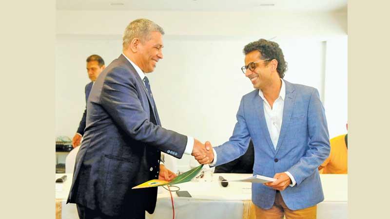 Hasib Omar (right) the Executive Director of Moose Clothing presents the sponsorship of the Sri Lanka rugby team to Rizly Illyas the president of SLR (Picture by Wasitha Patabendige)