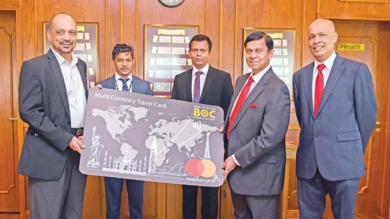 Chairman, Bank of Ceylon, Kanchana Ratwatte presents a replica of the Travel Card to Central Bank Goveronor Ajith N. Cabraal.