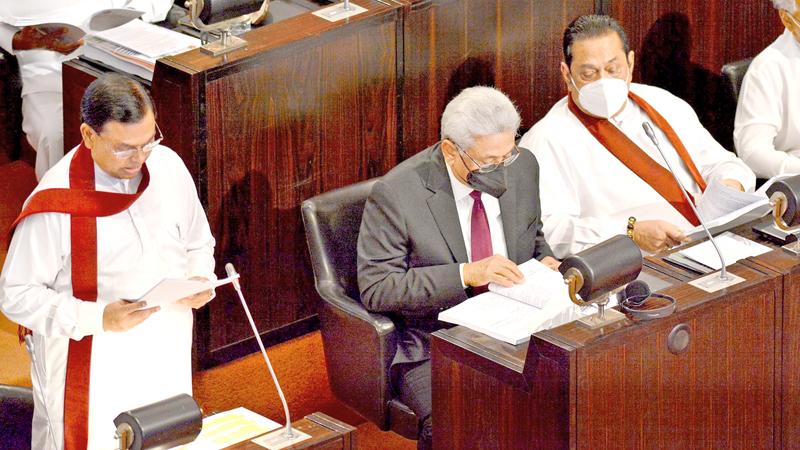 Finance Minister Basil Rajapaksa delivering the 2022 Budget speech in Parliament on Friday accompanied by President Gotabaya Rajapaksa and Prime Minister Mahinda Rajapaksa. Pic: Sulochana Gamage  