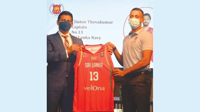 Captain of the Sri Lanka basketball team Clinton Stallone (right) receiving his jersey from Dr. Gihan de Soysa, the CEO of Velona Garments (Pic by Ranjith Asanga)