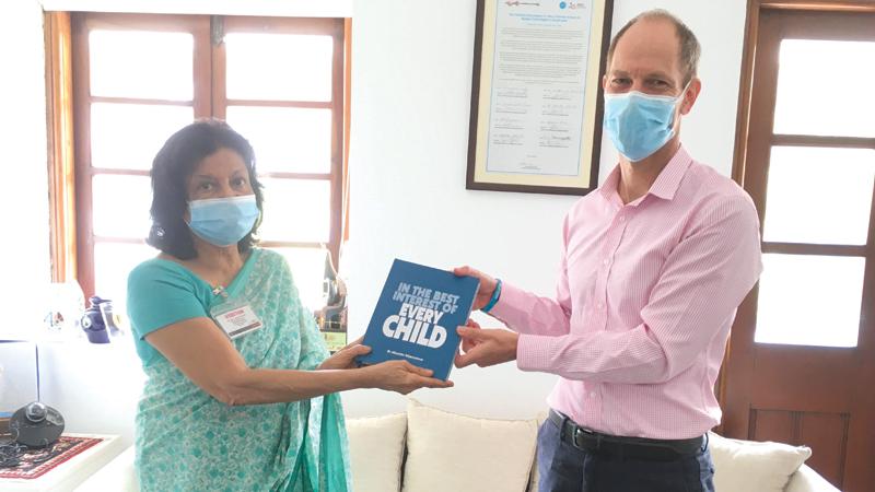 Public health veteran Dr. Hiranthi Wijemanne presenting her autobiography to the UNICEF country Representative to Sri Lanka Christian Skoog