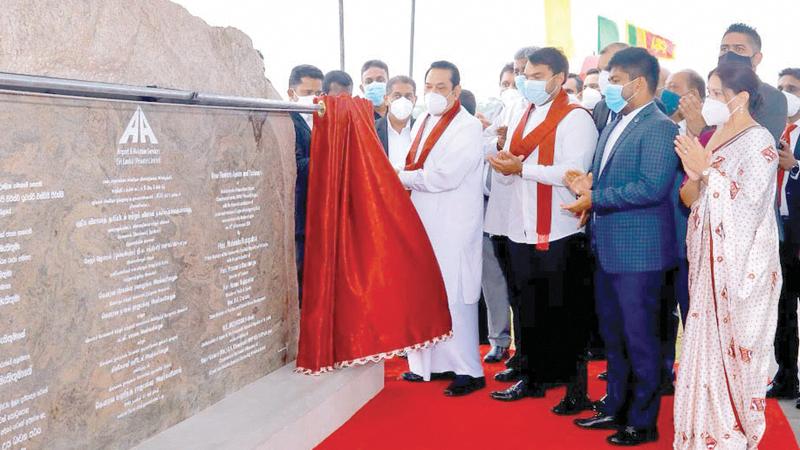Prime Minister Mahinda Rajapaksa unveils the plaque to open the new aircraft apron and taxi area at the Bandaranaike International Airport in the presence of other dignitaries. 