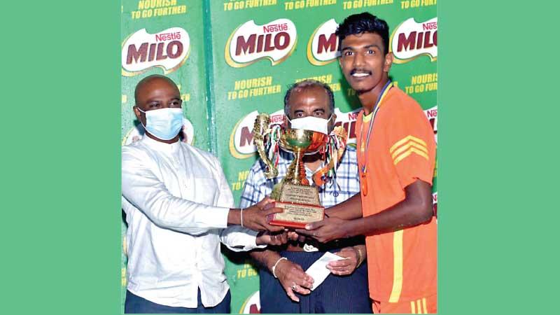 Ayantha Savinda (right) the captain of the Sarasavi SC team receiving trophy from Madura Vithanage, Member of Parliament