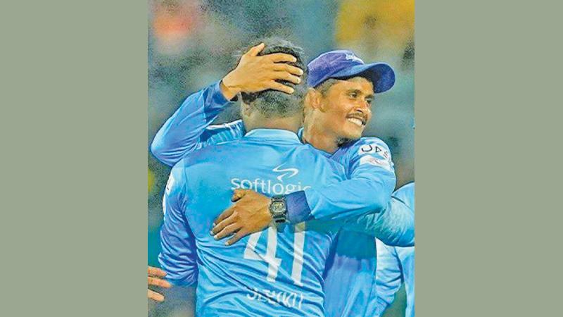 Colombo Stars bowler Jeffrey Vandersay (right) hugs a team-mate