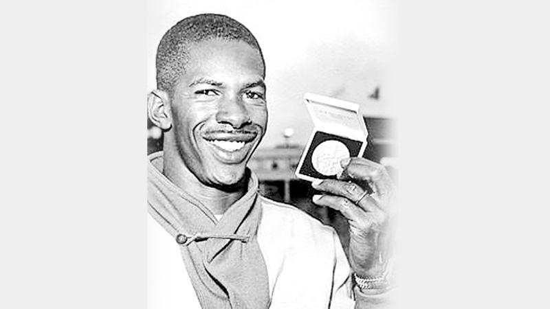 Adhemar displaying his second Olympic gold at Melbourne 1956