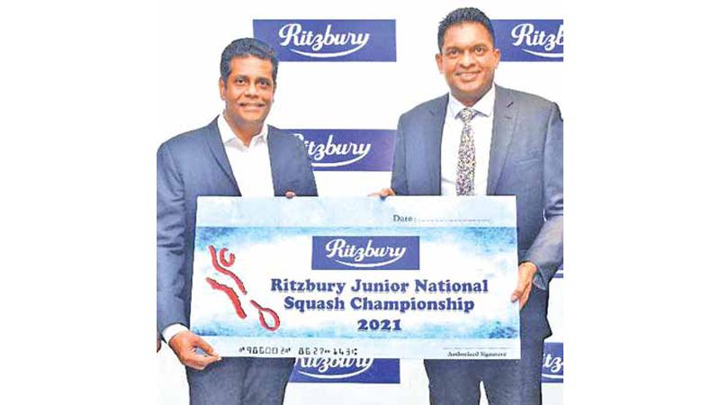President of Sri Lanka Squash, Suren Kohombange (left) receiving the sponsorship from Nilupul de Silva the General Manager of CBL Foods International