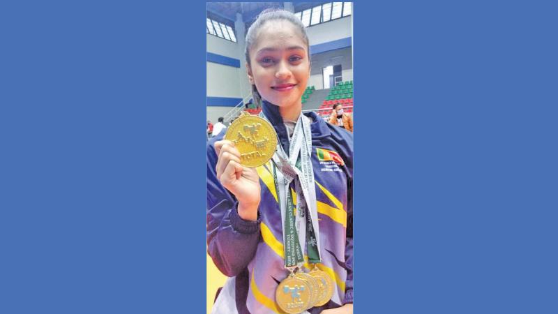 Senuki Dishalya poses with her gold medals