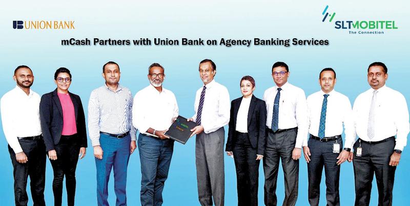 CEO of Mobitel, Chandika Vitharena exchanges the MoU with Director and CEO of Union Bank Indrajit Wickramasinghe. SLT-Mobitel  and Union Bank officials look on.