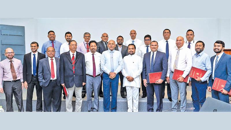 Minister of Industries, Wimal Weerawansa with the chairman and members of the Advisory Council of the Automobile Assembling and Automobile Components Manufacturing Industries in Sri Lanka.