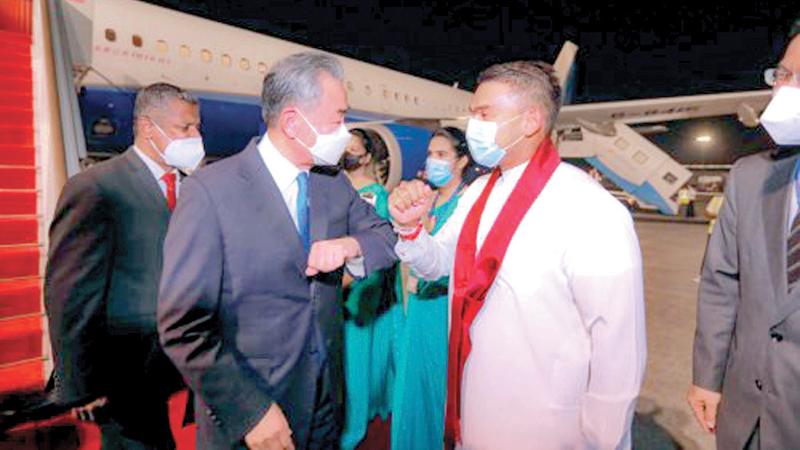 Minister Namal Rajapaksa greets Chinese Foreign Minister Wang Yi on arrival at the BIA.