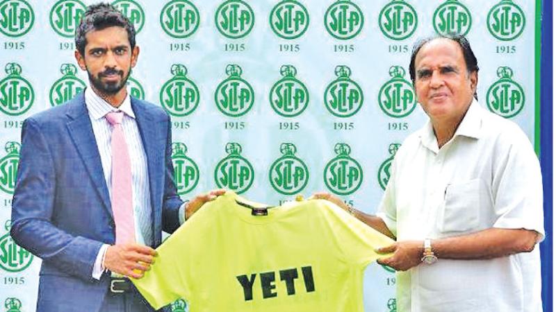 Director of Yeti Dr. Dilshan Balasuriya (left) presents a Yeti T-Shirt to Iqbal bin Issack the president of SLTA
