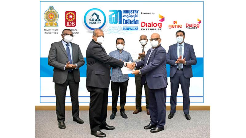 Mr. Navin Pieris, Group Chief Officer of Dialog Enterprise handing over the Title Sponsorship confirmation to Mr. Upasena Dissanayake, Chairman, Industrial Development Board, in the presence of Hon. Wimal Weerawansa, Minister of Industries, General DayaRatnayaka, Secretary, Ministry of Industries, Mr. ChannaAmarasekara, Head of Emerging Business, Dialog Axiata PLC and Mr. Harsha Samaranayake, Senior General Manager - Brand and Media, Dialog Axiata PLC.