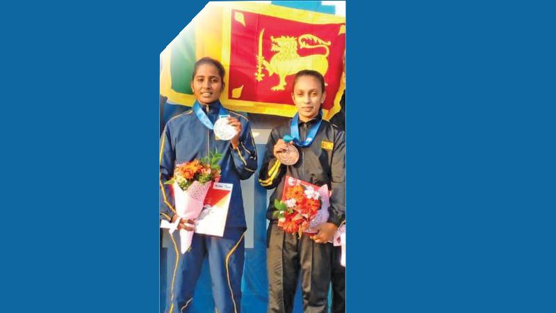 Silver medallist Uthpala Sewwandi (left) and bronze medallist Malshani Lokuge