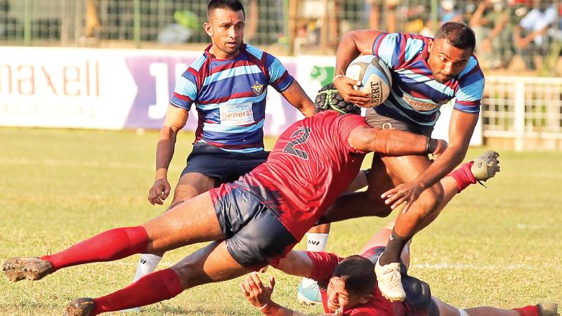 Air Force fly-half Ishara Madushan attempts to run through CR’s defence with centre Gayantha Iddamalgoda in support in their league rugby match at Longden Place yesterday (Pic by Thilak Perera)