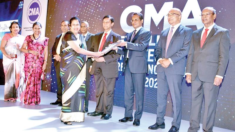An Aitken Spence official receives the award.