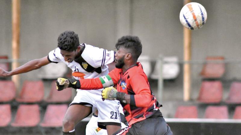 Mohamed Manaf of Colombo FC heads the ball away from Aabdul Rahim the Slave Island XI goal keeper to score