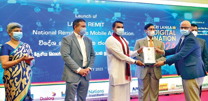 Minister Namal Rajapaksa presents a token of appreciation to Chief Marketing Officer of Mobitel, Shashika Senarath. Central Bank Governor Ajith Nivard Cabraal, Deputy Governor Mrs. Yvette Fernando, Chairman, Lanka Clear, Dr. Kenneth De Zilwa, and Assistant Governor, Payments and Settlements Department, Dharmasri Kumaratunge look on.