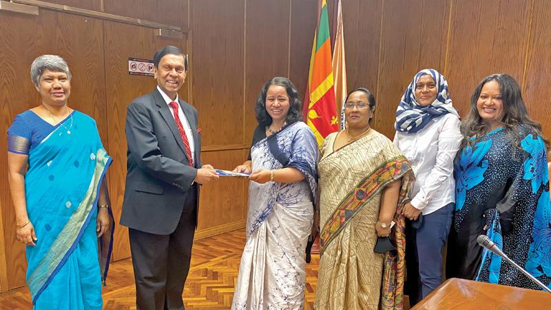 WCIC officials present the policy document to Central Bank Governor Ajith Nivard Cabraal.