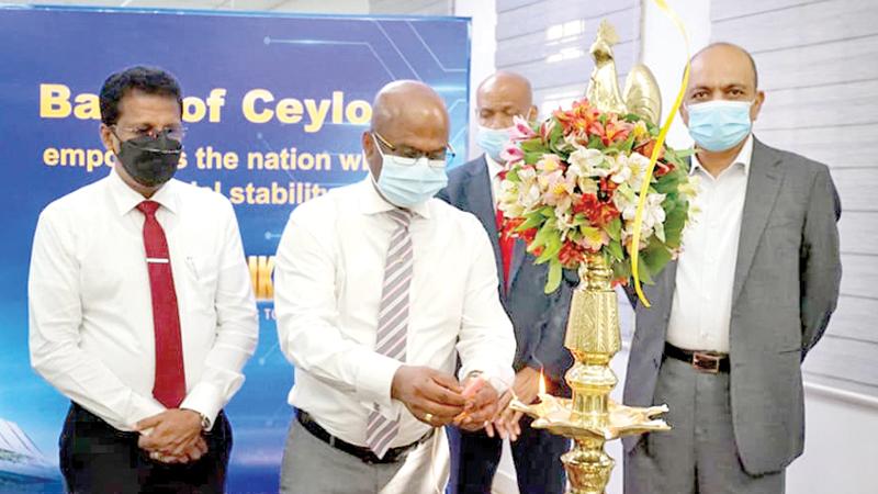 BOC Chairman Kanchana Ratwatte lights the oil lamp at the new building.
