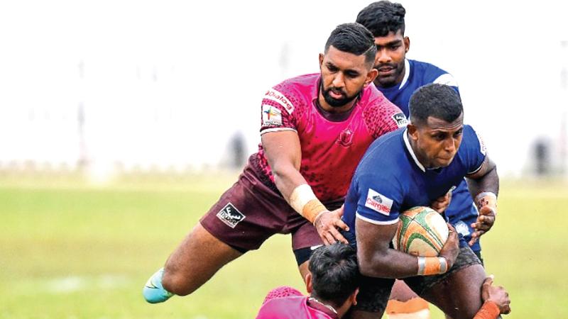 File photo of Havelocks player Nishon Perera attempting to bring down Police winger Mohan Wimalaratne in their rugby match which ended in a referring dispute at Police Park in Colombo last week