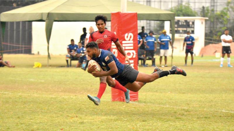 Police centre Vihanga Pivithuru flies over the line to score a spectacular try