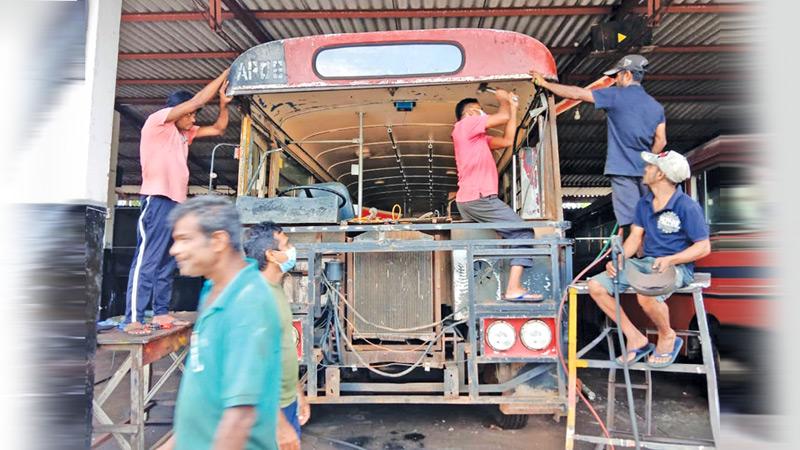 Multipurpose assistants repair a discarded bus at the Horowpothana CTB depot