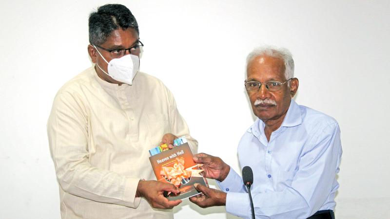 S. Pathmanathan (Sopa) presents his book and that of Kulandai Shanmugalingam to the   Governor of the North, Jeevan Thiagarajah
