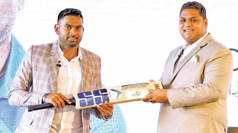 Bhanuka Rajapakse (left) is presented with a bat by Shiran Peiris whose Chariot he will drive to shield under privileged cricketers  (Pix by Sulochana Gamage)