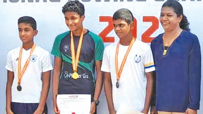 From left: Yenula Algoda  from St. Joseph’s College, Inesh Peiris from Asian International School and Dinuk Rajapakse from Royal College who finished the boys U-14 Sculls event in second, first and third places respectively after receiving their medals from Susanthika Jayasinghe who was the chief guest at the Rowing Nationals yesterday