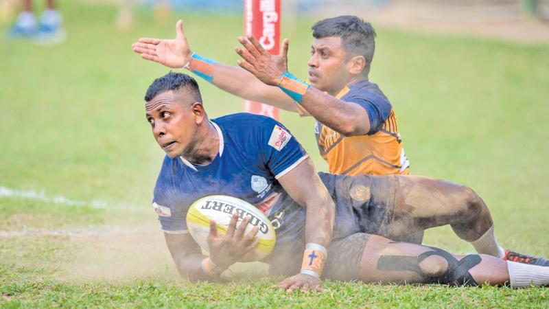 Police winger Janith Chanaka crosses the line to score beating Army defender Dilshara Kodagoda