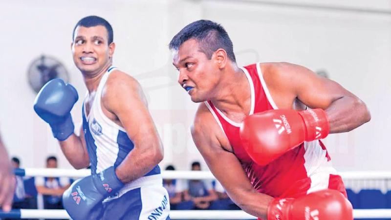 Rathnasiri (blue) evades a punch against an Air Force pugilist