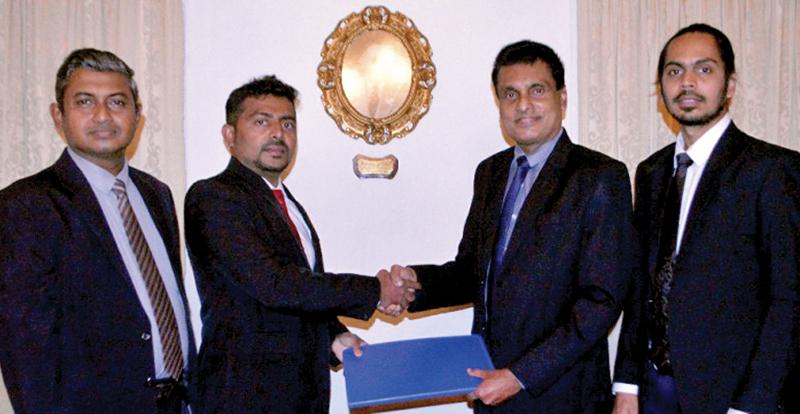 Representatives of the two companies exchange the agreement after the signing at the head of office of Alliance Finance. From left - Senior Manager Marketing and Branding, Alliance Finance, Lushan Perera, Chief Commercial Officer, Alliance Finance, Ajantha Kumara, General Manager, Software, OpenArc, Prabhath Nedurana and Head of Cloud Developments, OpenArc, Akila Delapalage.