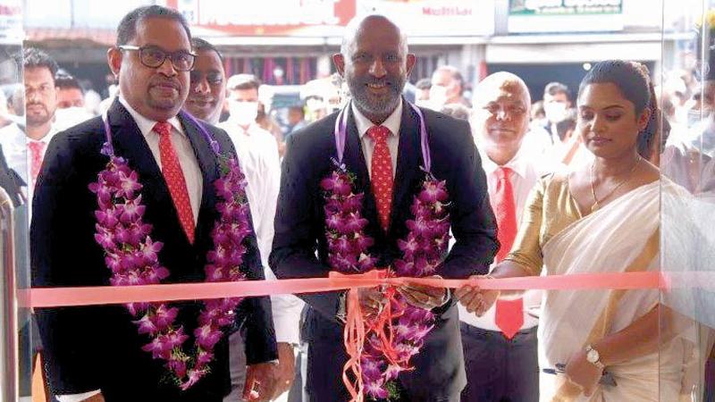 The chief guest, Senior Deputy General Manager of Pan Asia Bank, Naleen Edirisinghe and guest of honour Assistant General Manager, Operations and Administration of Pan Asia Bank, Harsha Kurukulasuriya open the branch. Manager, Galewela branch, Nimeshika Nanayakkara looks on.