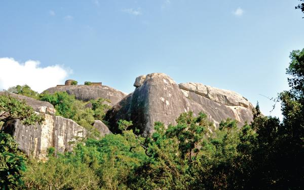 A stupa on top  of a massive rock boulder in the  Kudumbigala hermitage