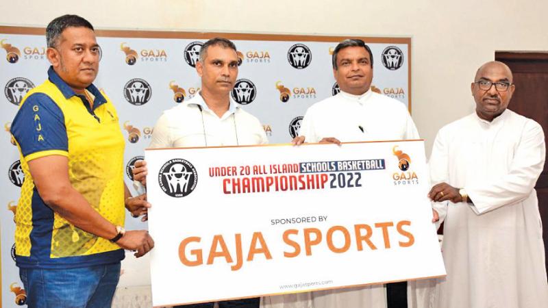 Vice President of Gaja Sports Clifford Greig (second left) presenting the token sponsorship to SLSBA president Fr Rohitha Rodrigo (second right) in the presence of Gaja Sports CEO Gayath Jayasinghe (left) and SLSBA secretary Rev Bro. RJ Jeyakanthan 