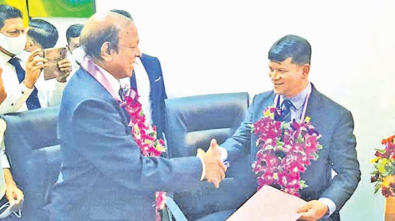 Football secretary Upali Hewage (left) and president Jaswar Umar congratulate each other after their election last year