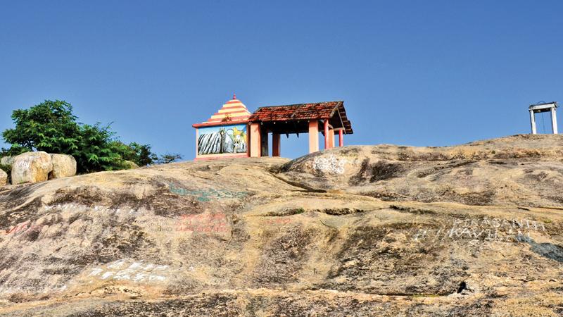A shrine stands on a boulder at Okanda Devalaya