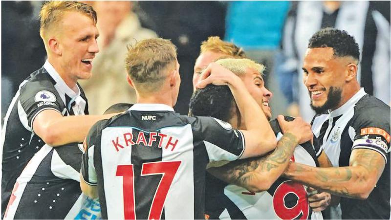 Newcastle players celebrate their win over favourites Arsenal