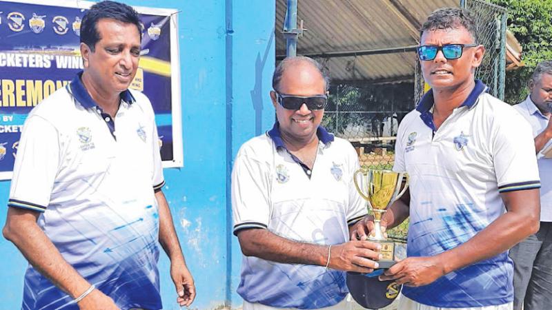 Ravi Punchihewa the former St. Thomas’ Matale skipper who was adjudged player of the tournament (right) receiving his trophy from the school principal Dhammika Hewawasam