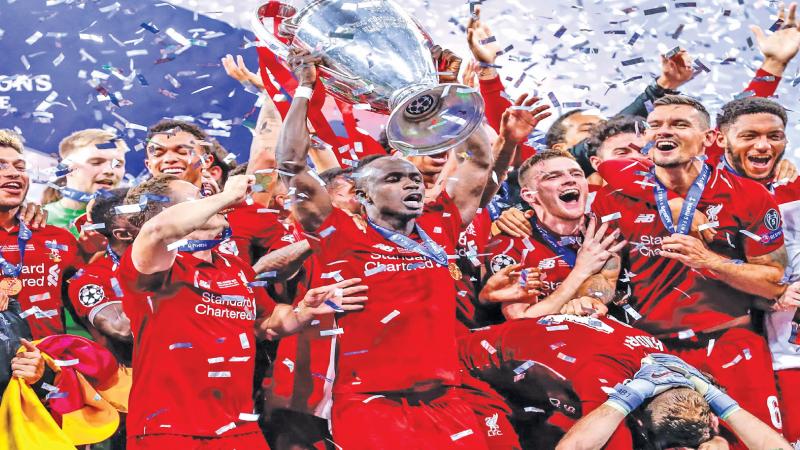 The Liverpool team celebrate winning the Champions League final