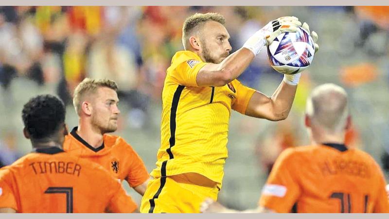 Netherlands’ goalkeeper Jasper Cillessen (C) controls the ball