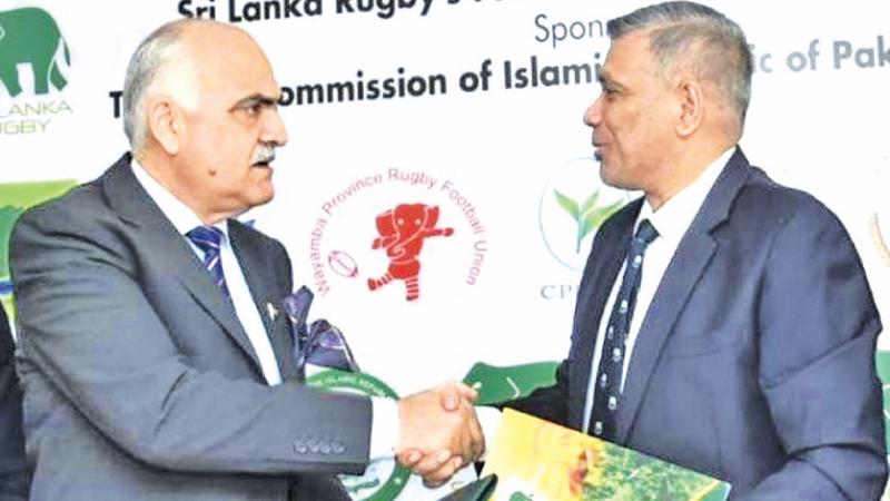 Pakistan's High Commissioner in Colombo Major General Umar Farook Burki (left) and Sri Lanka Rugby president Rizly Illyas come together in signing an Agreement to take the sport forward (Pic by Samantha Weerasiri)