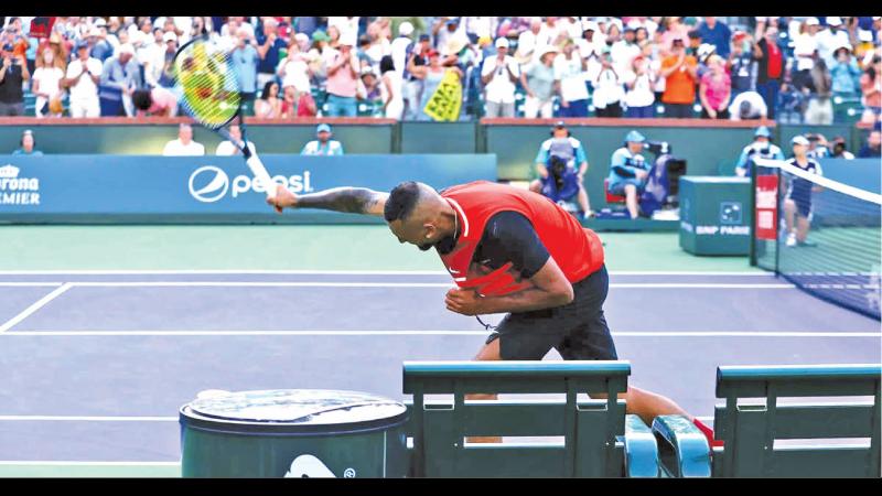 Nick Kyrgios smashes his racquet