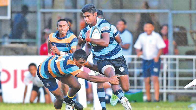 Wesley College centre Shane Hopwood makes a break during their match against Vidyartha College at Longden Place in Colombo