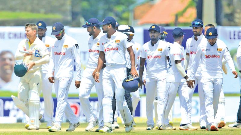 Sri Lanka captain Dimuth Karunaratne (second from left) walks back with his team after losing the first Test to Australia in Galle on Friday (Pic SLC)