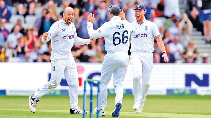 Jack Leach celebrates his feat with team-mates Ben Stokes and Joe Root