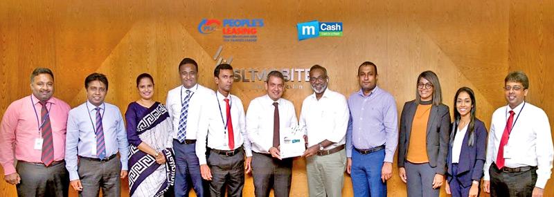CEO and GM, People’s Leasing and Finance, Shamindra Marcelline exchanges the MoU with CEO, Mobitel, Chandika Vitharena. Looking on are: Deputy General Manager, Pre-Paid, Shiang Wong, Manager, Mobile Financial Services, Rishani Gunarathne, Executive, Mobile Financial Services, Amanda Wijesinghe, DGM, Operations, People’s Leasing and Finance, Laksanda Gunawardena, DGM, IT, Prabath Gunasena, Manager, Senior Business System Architect, Sherine Inoka Dabare, Niranjan Selvanayagam, Manager, Product Development