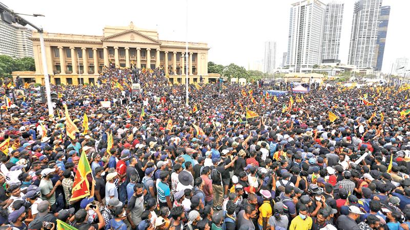 Protestors occupy the Presidential Secretariat after breaching the Police cordon and barricades yesterday. Pic: Sulochana Gamage