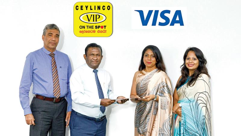 Managing Director, Ceylinco General Insurance, Upali Witharana presents the agreement to Country Manager, Visa / Sri Lanka and the Maldives, Ms. Avanthi Colombage. General Manager, City Office, Ceylinco General Insurance, Roshan Ranasinghe and Director, Visa / Products and Solutions, Ms. Gimali Soysa look on.